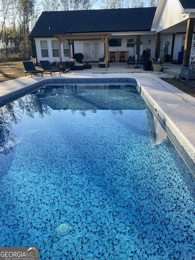 view of pool with outdoor lounge area and a patio