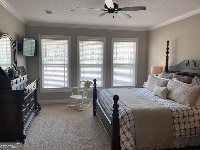 carpeted bedroom featuring ceiling fan, crown molding, and a textured ceiling