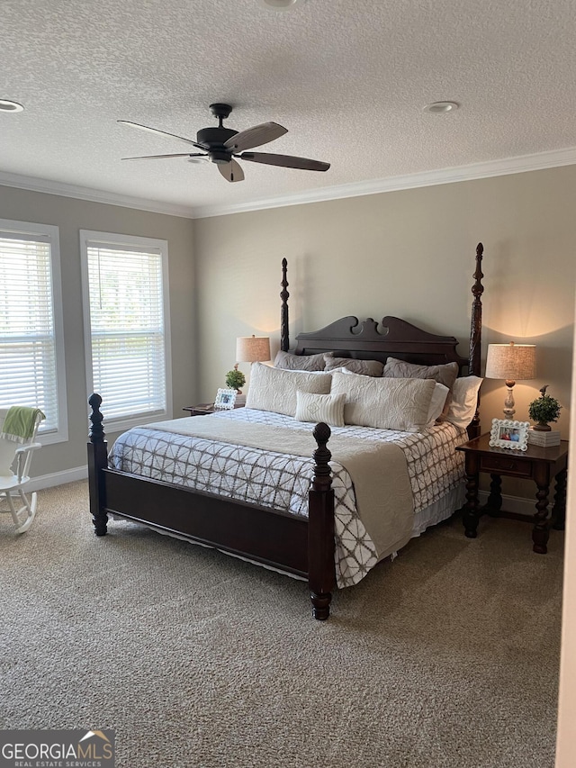 carpeted bedroom featuring a textured ceiling, ceiling fan, and crown molding