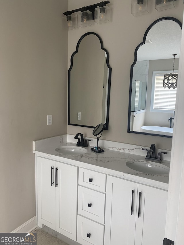 bathroom with a bathing tub and vanity