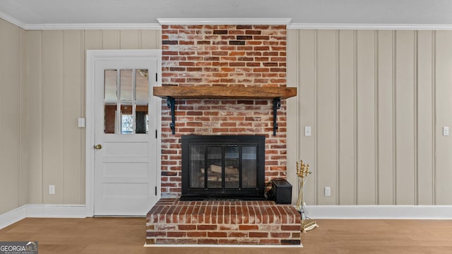 details featuring a fireplace, wood-type flooring, and ornamental molding