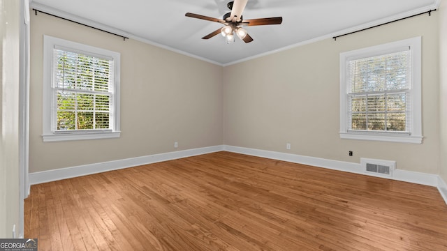 spare room featuring light wood-type flooring, ceiling fan, and ornamental molding