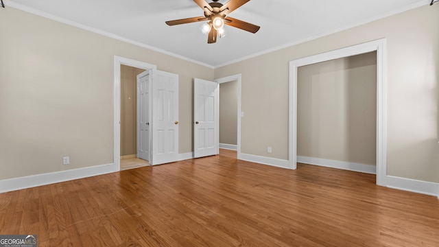 unfurnished bedroom featuring hardwood / wood-style flooring, ceiling fan, and ornamental molding