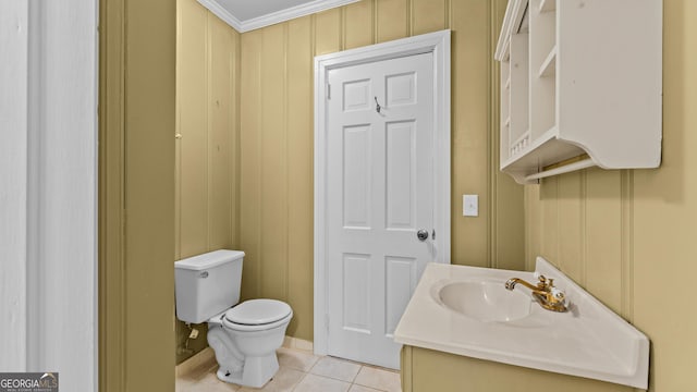 bathroom with tile patterned floors, vanity, toilet, and ornamental molding