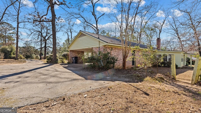 view of side of home with a carport