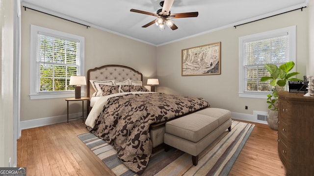 bedroom with ceiling fan, light hardwood / wood-style flooring, and crown molding