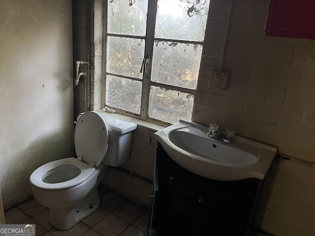 bathroom with tile patterned flooring, vanity, and toilet