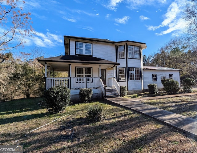 view of front of house featuring covered porch and a front yard