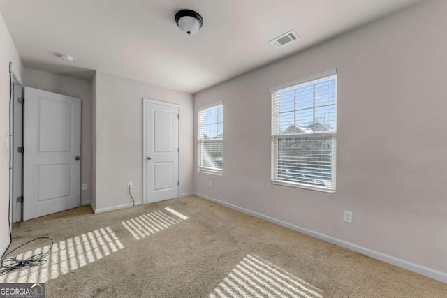 unfurnished bedroom with light carpet