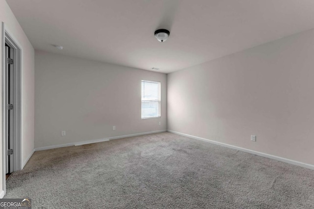 unfurnished room with light carpet