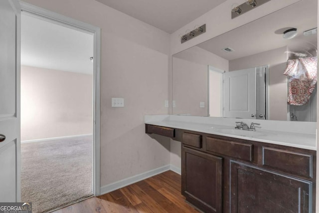 bathroom with vanity and wood-type flooring