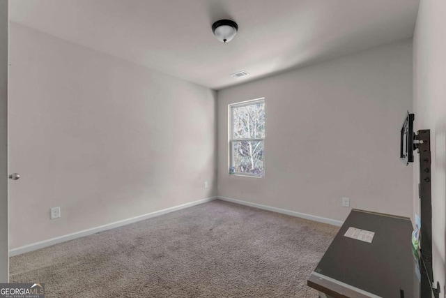 workout room featuring light colored carpet