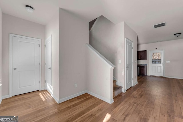 hallway with light hardwood / wood-style floors