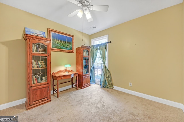 misc room featuring ceiling fan and light carpet