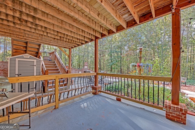 wooden deck featuring a storage shed