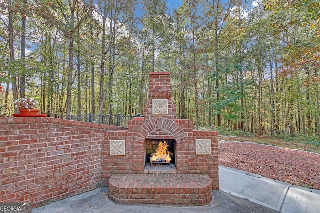 view of patio with an outdoor brick fireplace