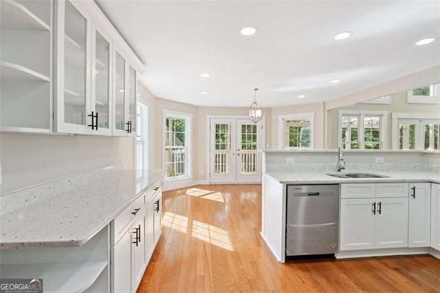 kitchen with french doors, sink, dishwasher, white cabinetry, and hanging light fixtures