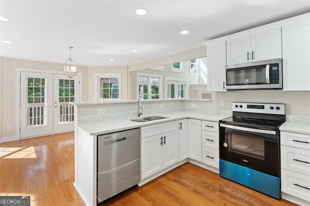 kitchen with sink, white cabinets, stainless steel appliances, and french doors