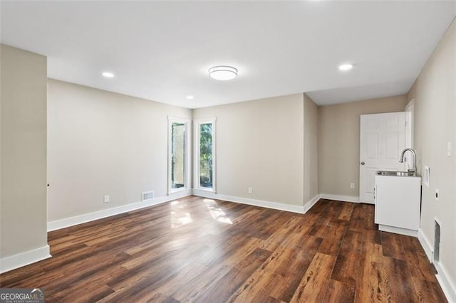 empty room featuring dark hardwood / wood-style flooring and sink