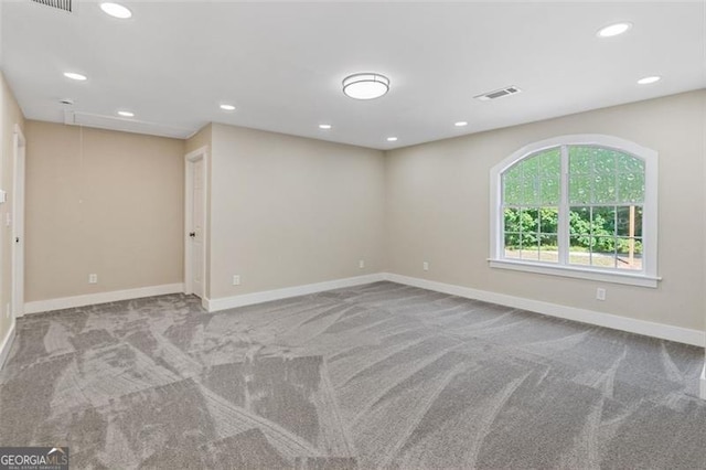 unfurnished room featuring light colored carpet