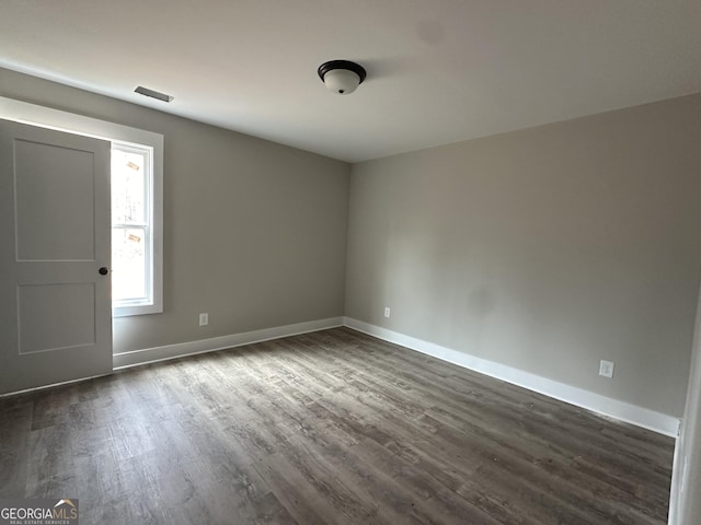 unfurnished room with dark hardwood / wood-style floors