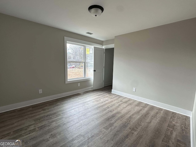 unfurnished bedroom featuring dark hardwood / wood-style floors