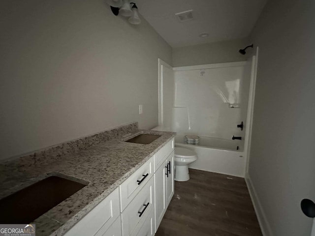 full bathroom with wood-type flooring, vanity, toilet, and  shower combination