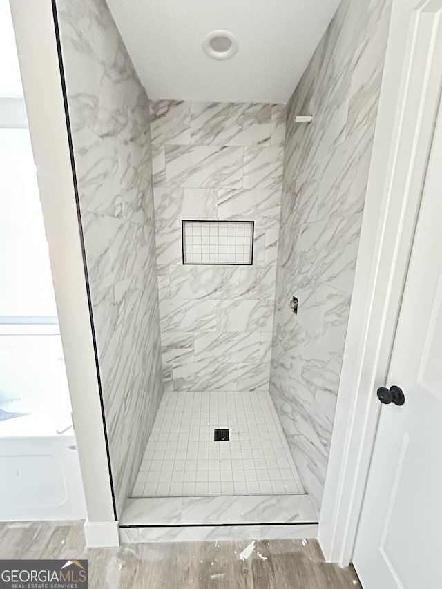 bathroom with tiled shower