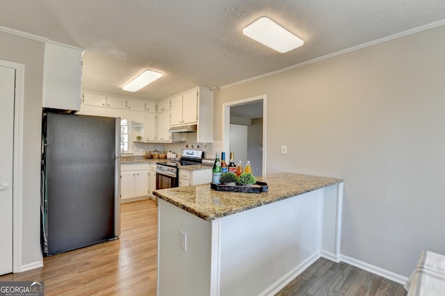 kitchen featuring appliances with stainless steel finishes, light hardwood / wood-style floors, kitchen peninsula, light stone counters, and white cabinets