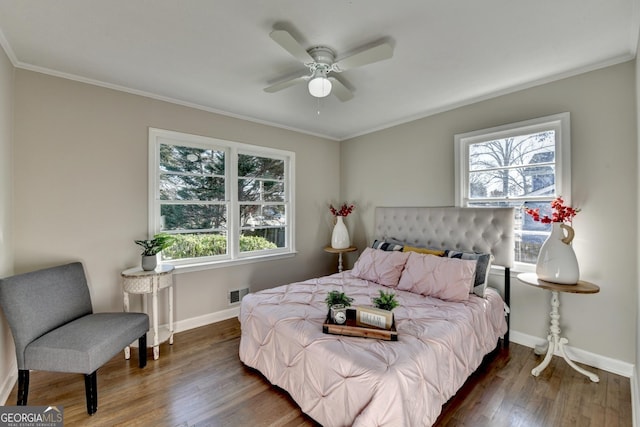 bedroom with dark wood-type flooring, ceiling fan, and multiple windows