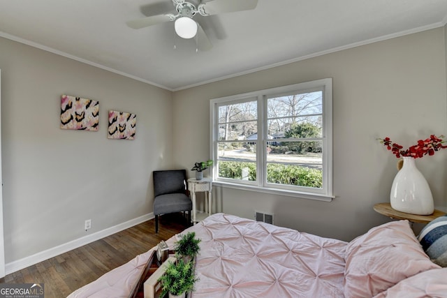 bedroom with ceiling fan, crown molding, and dark hardwood / wood-style floors