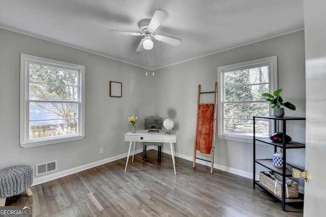 office featuring a healthy amount of sunlight, ceiling fan, ornamental molding, and hardwood / wood-style floors