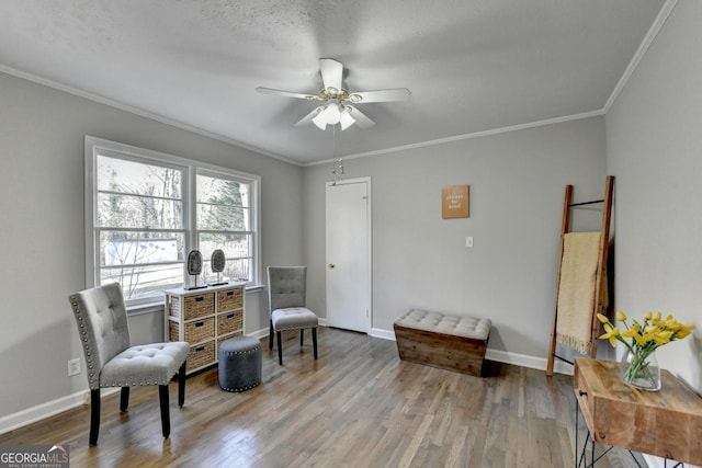 living area featuring ceiling fan, light wood-type flooring, crown molding, and a textured ceiling