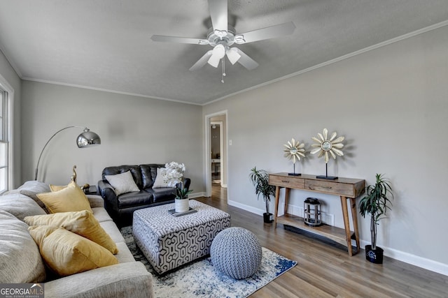 living room featuring ornamental molding, ceiling fan, a textured ceiling, and wood-type flooring