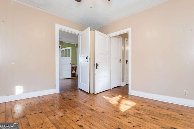 spare room with wood-type flooring, a textured ceiling, and ceiling fan