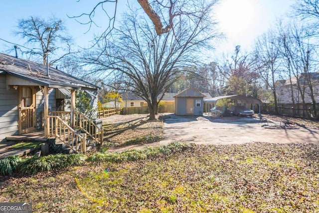 view of yard featuring a storage unit and a carport