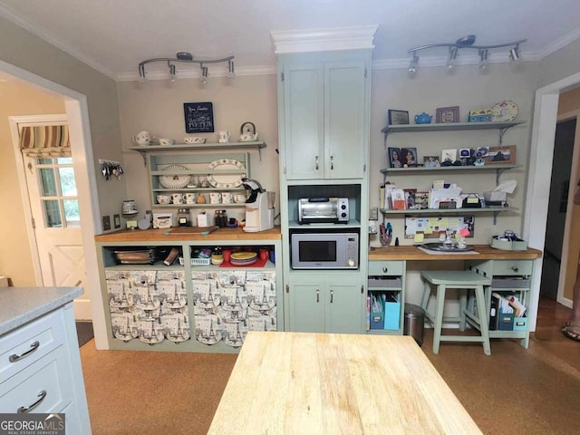 kitchen with butcher block counters, white microwave, and ornamental molding