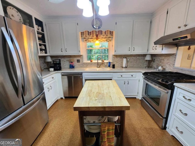 kitchen featuring decorative backsplash, appliances with stainless steel finishes, sink, white cabinets, and butcher block countertops