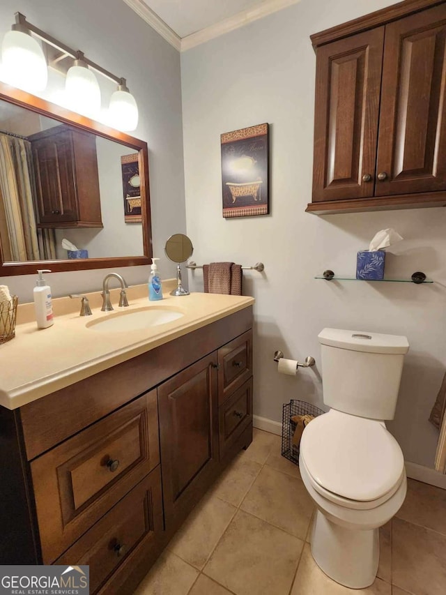 bathroom featuring tile patterned floors, vanity, toilet, and ornamental molding