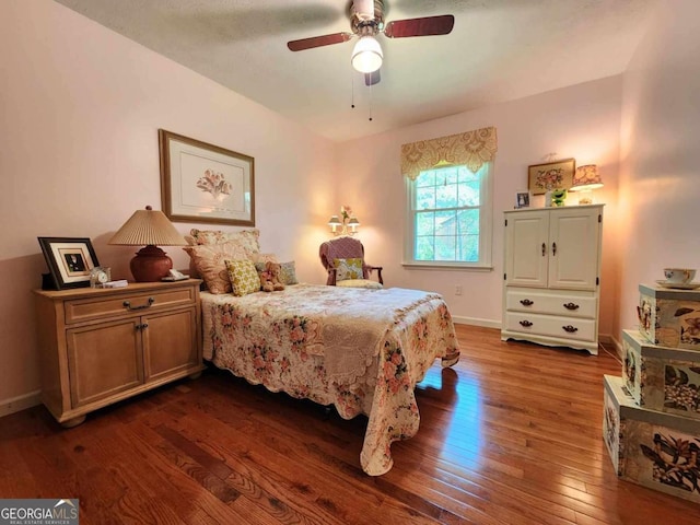 bedroom featuring ceiling fan and dark hardwood / wood-style floors