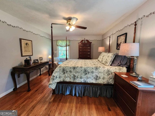 bedroom featuring ceiling fan, hardwood / wood-style floors, and a textured ceiling