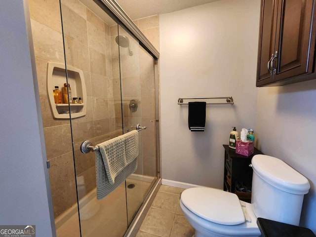 bathroom with tile patterned flooring, toilet, and walk in shower