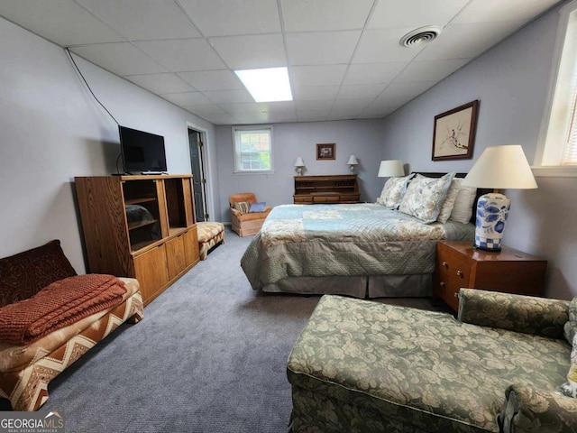 bedroom featuring a paneled ceiling and carpet