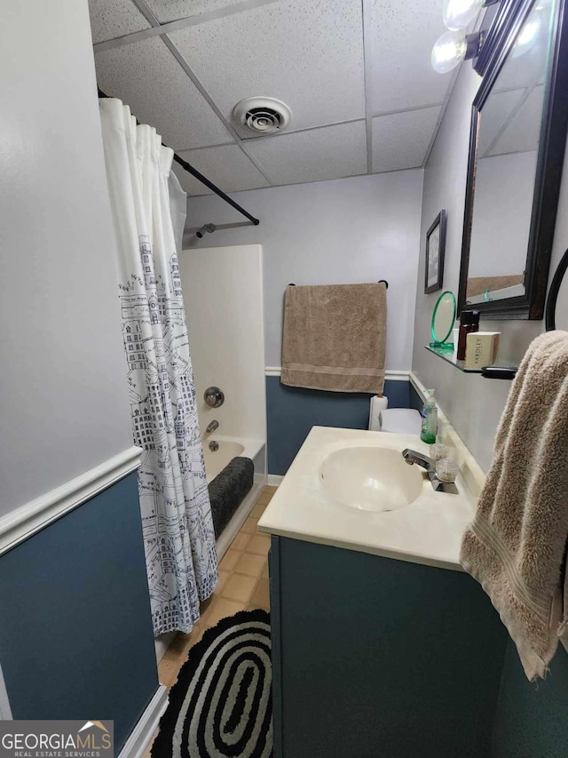 bathroom featuring vanity, shower / tub combo, and a paneled ceiling