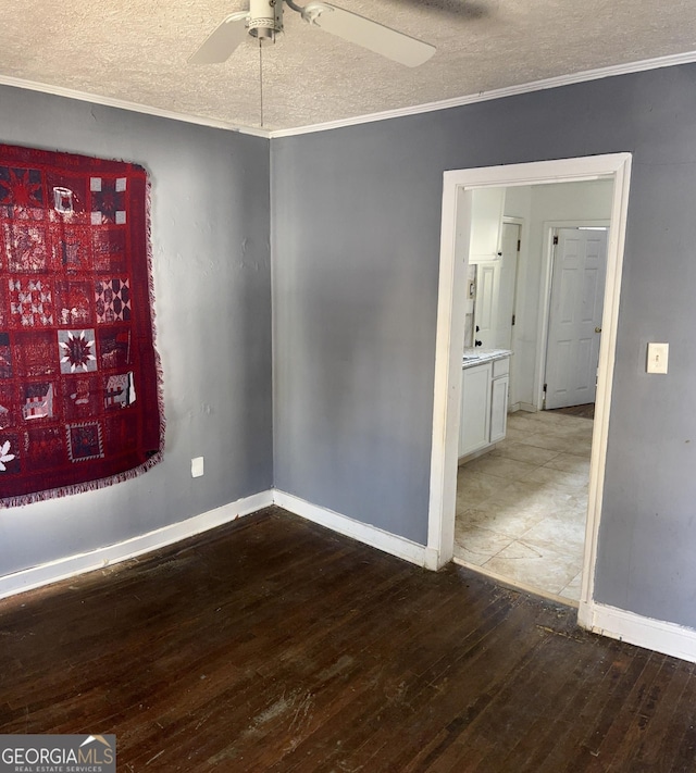 unfurnished room with ceiling fan, ornamental molding, a textured ceiling, and hardwood / wood-style flooring