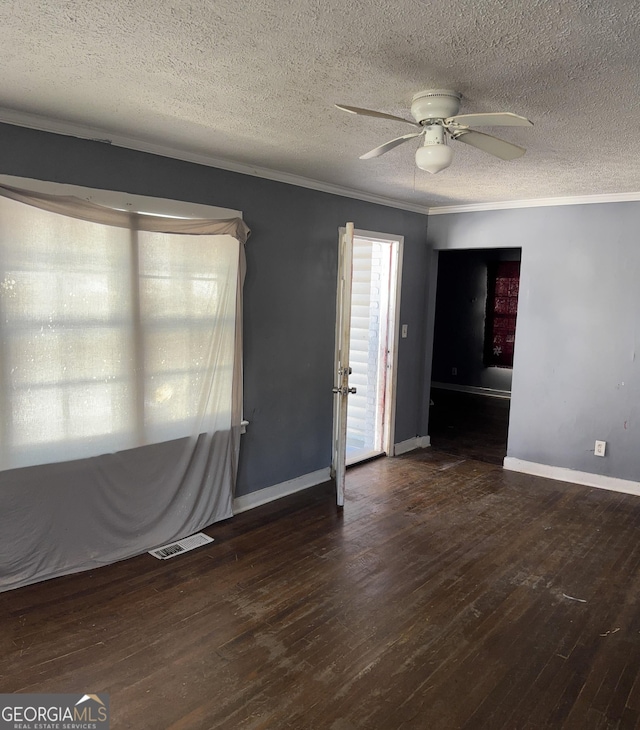 empty room featuring ornamental molding, a textured ceiling, ceiling fan, and dark hardwood / wood-style flooring