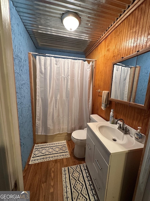 bathroom with hardwood / wood-style flooring, vanity, wood ceiling, and toilet