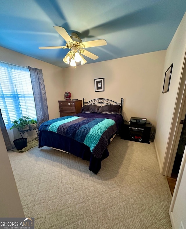 bedroom with ceiling fan and carpet flooring