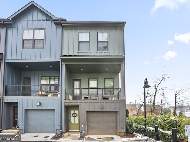 view of front of property featuring a balcony and a garage