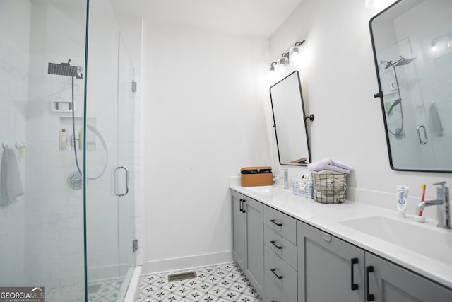 bathroom featuring vanity and a shower with shower door